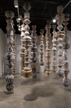 an art installation with multiple wooden sculptures on the wall and in between them are white walls