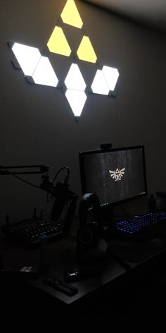 a desk with a computer, keyboard and mouse on it in a dark office area