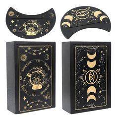 two black and gold bookends with the moon and stars on them, one is open