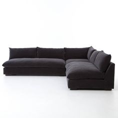 a large black couch sitting on top of a white floor