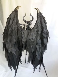 an artistic sculpture made out of black feathers