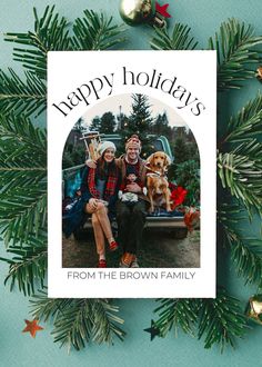 a christmas card with the words happy holidays from the brown family and two people sitting on a truck