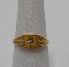 Vintage Avon tiny, dainty gold tone ring with a tiny clear rhinestone in the center. 1/4" x 1/2" setting. Size 8. Excellent condition. Gold Adjustable Birthstone Ring With Diamond, Formal Gold Birthstone Ring With Single Diamond, Adjustable Gold Birthstone Ring With Single Diamond, Vintage Gold Engraved Ring With Single Diamond, Antique Gold Birthstone Promise Ring, Vintage Gold Signet Ring With Birthstone, Gold Dainty Birthstone Ring For Formal Occasions, Vintage Gold Signet Ring With Single Diamond, Collectible 14k Gold Cameo Rings