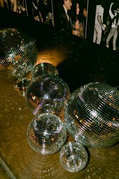 shiny disco balls are lined up on a table