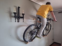 a man on a bike hanging from the wall