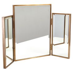 a large mirror sitting on top of a white floor