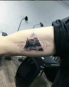 a person with a triangle tattoo on their arm