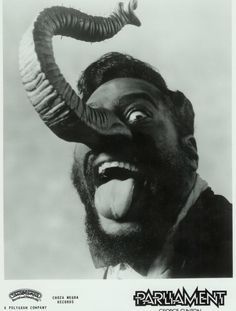 a man with long horns sticking out his tongue