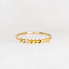 Inspired by the mystical allure of birthstones. This exquisite ring showcases 9 shimmering citrine gemstones, meticulously crafted in 14k gold. Perfect as a meaningful gift to yourself or a loved one born in November! Citrine (November birthstone) is the stone of positivity and optimism 3 deep citrine stones, each with a width of 1.75mm 6 light citrine, each with a width of 1.75mm 14k yellow gold band Citrine Birthstone Ring, Citrine Birthstone, Born In November, November Birthstone Ring, Citrine Jewelry, Casual Jewelry, Citrine Ring, Citrine Stone, November Birthstone