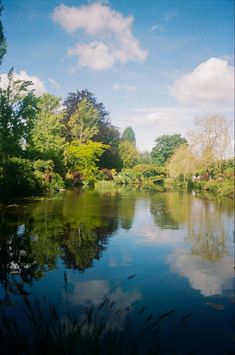 the water is calm and clear for us to see in this photo with trees around it