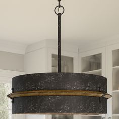 a black and white chandelier hanging from the ceiling in a kitchen with marble counter tops