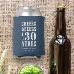 a beer can and some food on a table with burlocked fabric behind it