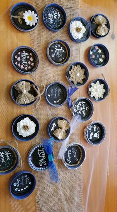 there are many small blue bowls with flowers in them on the table and one is empty