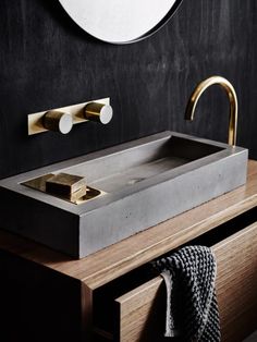 a bathroom sink sitting on top of a wooden counter next to a wall mounted mirror