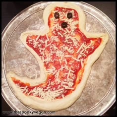 a pizza shaped like a ghost with cheese and olives