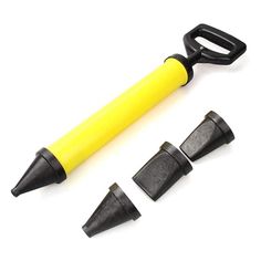 three black and yellow plastic objects next to each other on a white surface with one pen in the middle