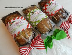 four packages of christmas treats are wrapped in cellophane and tied with green ribbon