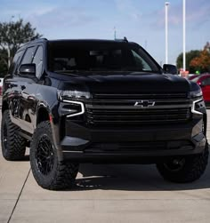 a black truck parked in a parking lot