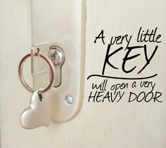 a door handle with a heart shaped key hanging from it's side and the words, a very little key will open a very heavy door