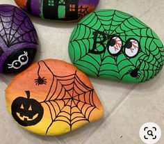 three painted rocks with halloween decorations on them