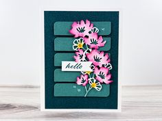 a card with pink flowers on it and the words hello written in white letters above them