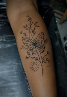 a woman's arm with a flower tattoo on it