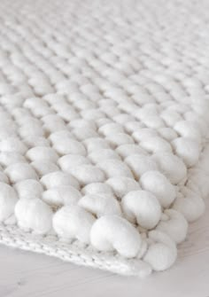 a white rug with pom - poms on it