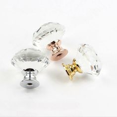 three different types of glass knobs on a white surface