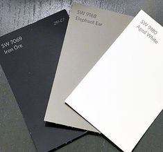 three different types of paint samples sitting on top of each other, one white and the other gray