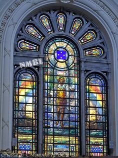 a large stained glass window in the middle of a building