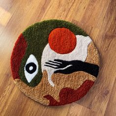 a round rug with an image of a hand holding a ball on top of it