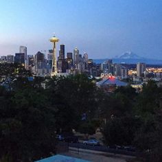 the seattle skyline is lit up at night