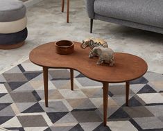 an elephant figurine sitting on top of a wooden table in a living room