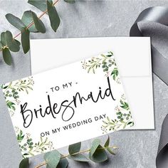 a card that says to my bridesmaid on my wedding day with greenery