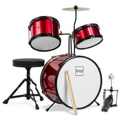 a red drum set with drums and stools on a white background for display purposes