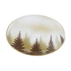 a white and brown plate with trees painted on the side, in front of a white background