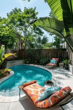 an outdoor swimming pool with lounge chairs around it and trees in the backround