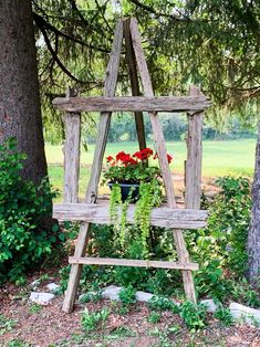 an old wooden ladder with flowers growing in it