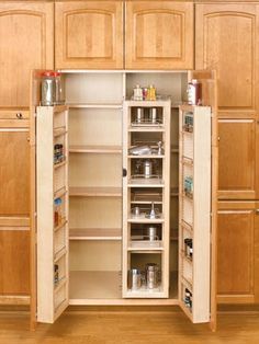 an open cabinet in the middle of a kitchen