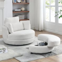 a white chair and ottoman in a living room