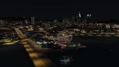 an aerial view of a city at night with ferris wheel and lights in the foreground