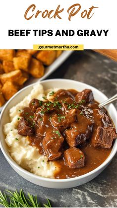 a bowl filled with beef and gravy on top of mashed potatoes