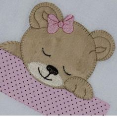 a teddy bear with a pink bow on it's head is peeking out from behind a blanket