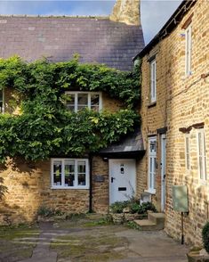 an old brick building with ivy growing on it