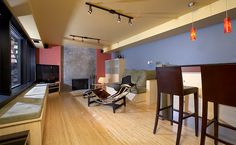 a living room filled with furniture and a fire place next to a kitchen counter top