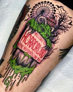 a tattoo on the leg of a person with green ink and an image of a ferris wheel