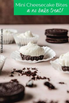 mini cheesecake bites with white frosting and oreo cookies in the background on a table