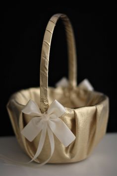 a gold basket with a white bow on it