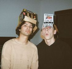 two young men with hats on their heads