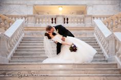 a bride and groom kissing on the steps at their wedding reception in washington dc, usa